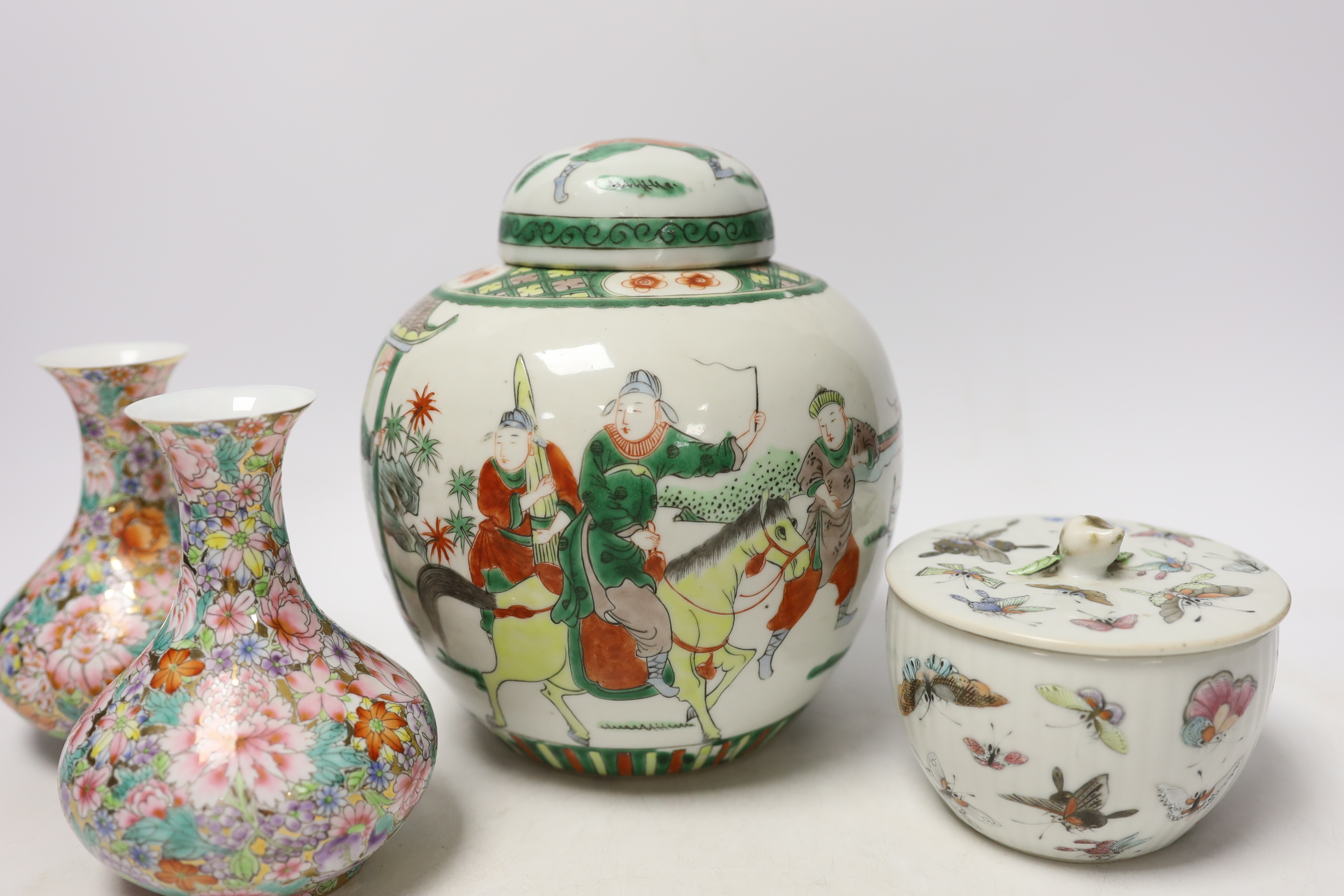 A Chinese famille rose 'butterfly' bowl and cover, Tongzhi mark and period, a famille verte jar and a pair of millefleur vases, tallest 19cm (4)